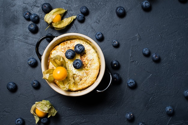 Classic English rice pudding. Blueberries and physalis