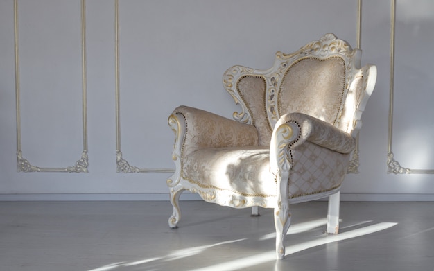 Classic fabric white armchair in white room