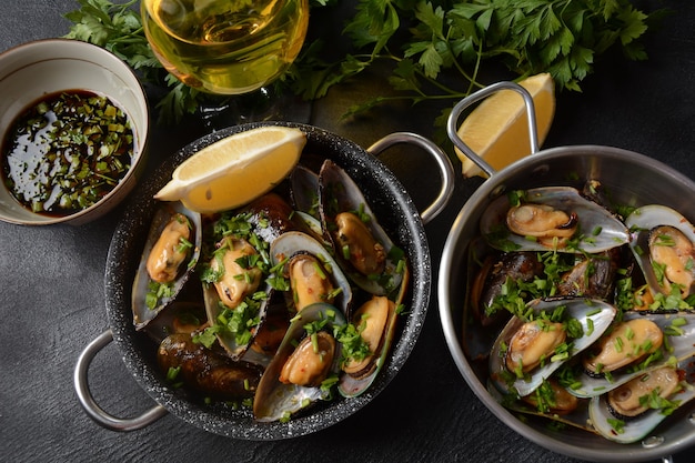 Classic French meal Moules mariniÃÂ¨re  Marinara mussels with garlic, sauce, lemon and parsley.