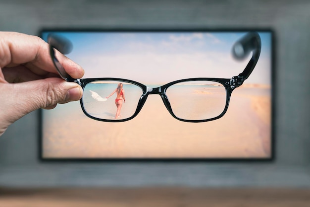 Photo classic glasses in front of tv screen glasses for viewing a stereo image protective glasses from negative impact of monitor while working on the computer vision loss correction of poor vision