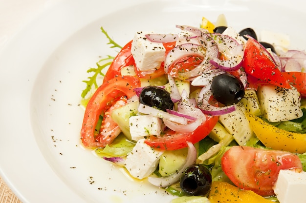 Classic greek salad on a dish in restaurant