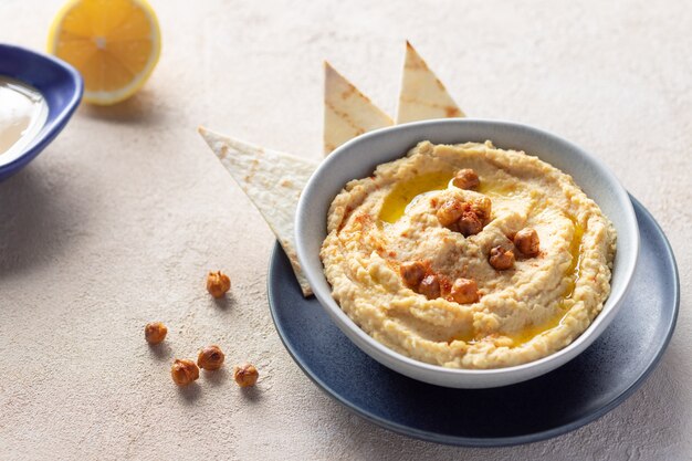 Classic hummus in bowl with chickpeas