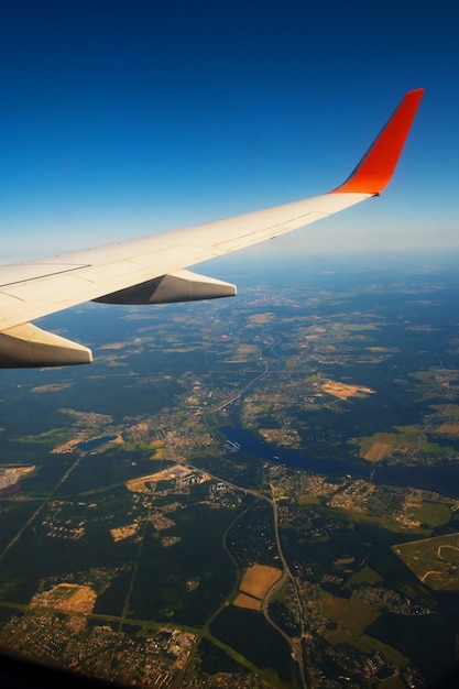 Classic image through aircraft window onto wing flight view over russia