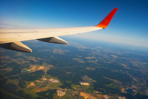 Classic image through aircraft window onto wing flight view over russia