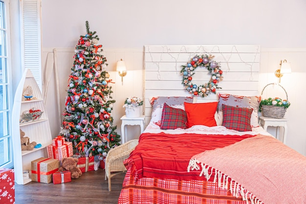 Classic interior room with christmas tree and traditional white\
red decorations modern clean white classical style interior design\
apartment bedroom christmas eve at home minimalist home design