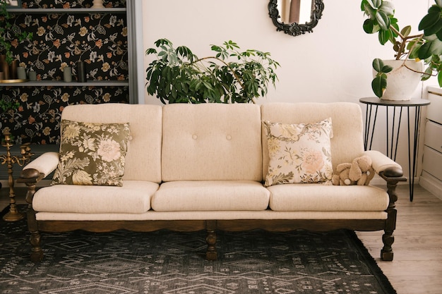 Classic interior with wooden sofa vintage sideboard mirror and flowers