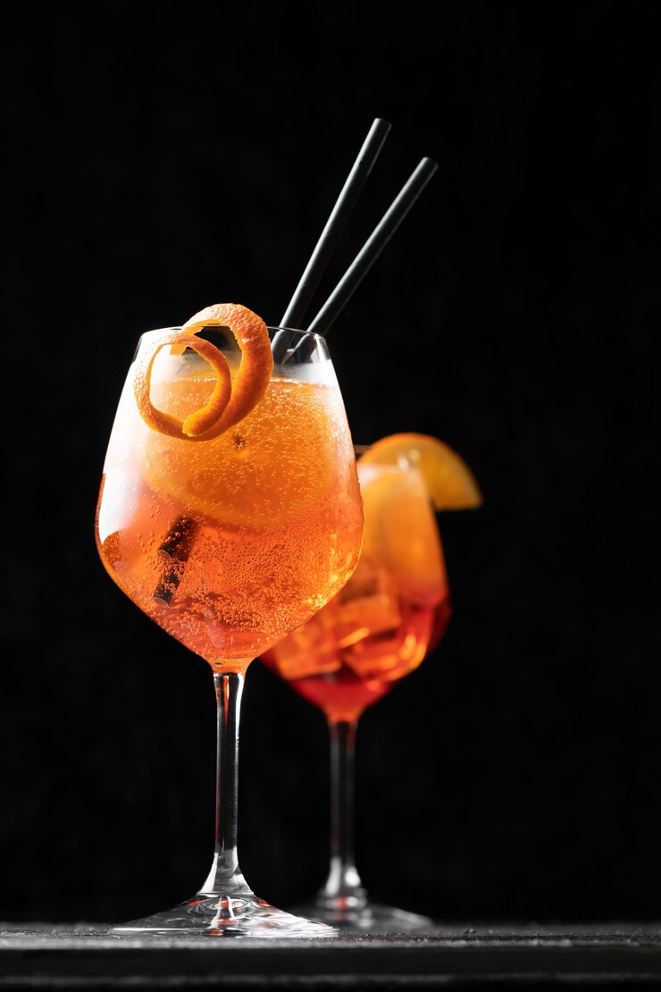 Классический итальянский коктейль Aperol Spritz в стакан на черном, крупным планом