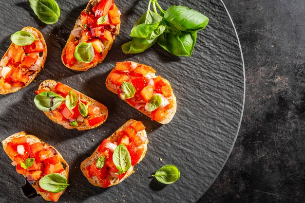 Classic italian bruschetta served on dark plate