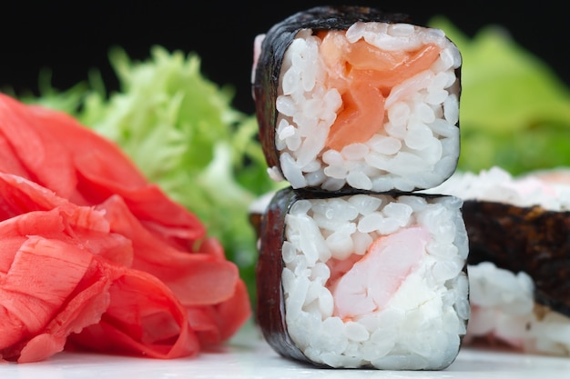 classic japanese sushi rolls in closeup against a dark background