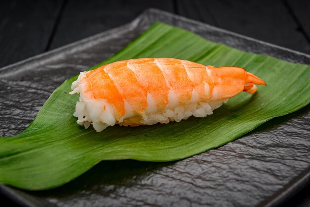 Classic Japanese sushi with shrimp on a dark background