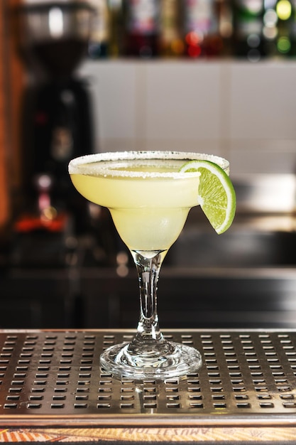 Classic lime margarita cocktail with tequila lime juice and salt on the edge of the glass