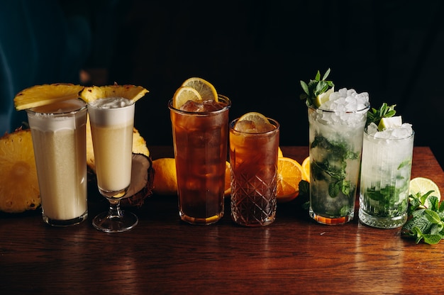 Classic long drink cocktails on the table Mojito long island and pina colada