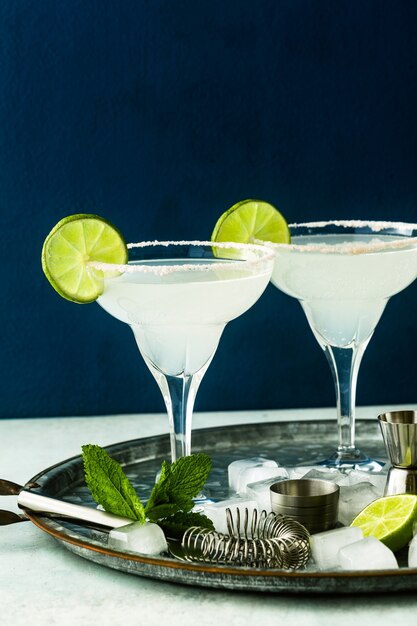 Classic margarita cocktail on the table with bar accessories.