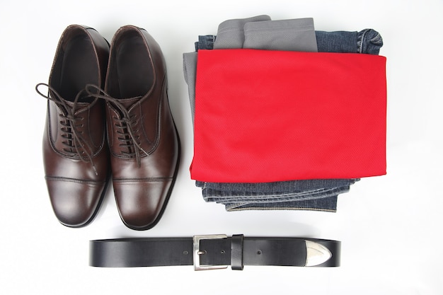 Classic men's brown shoes, belt and clothes on white