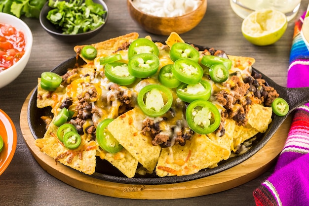 Classic nachos with ground beef and fresh jalapeno chili peppers.