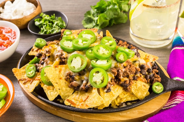 Classic nachos with ground beef and fresh jalapeno chili peppers.