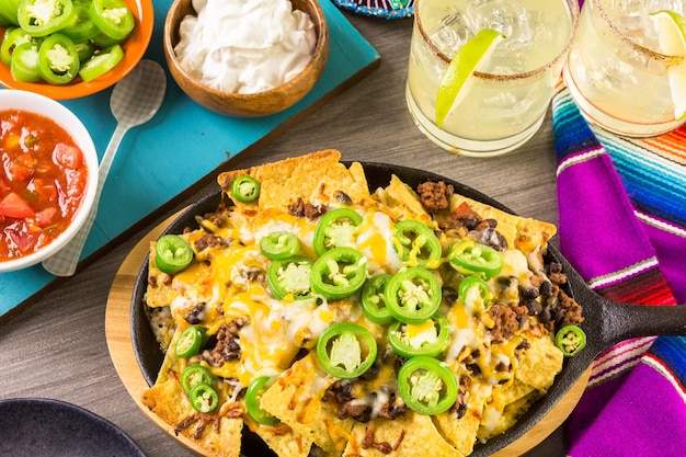 Classic nachos with ground beef and fresh jalapeno chili peppers.