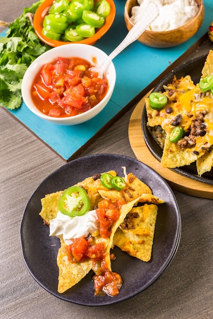 Classic nachos with ground beef and fresh jalapeno chili\
peppers.