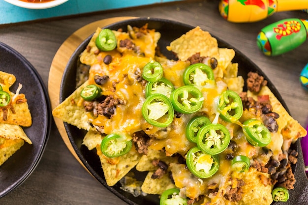 Classic nachos with ground beef and fresh jalapeno chili peppers.