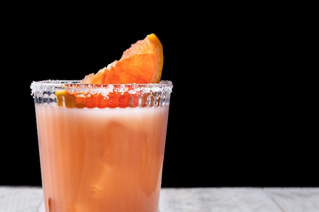 Classic paloma cocktail on white wooden table