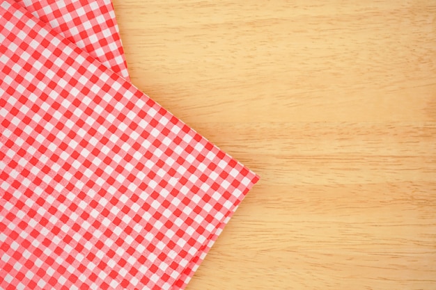 Classic pink plaid fabric or tablecloth on wood desk with copy space