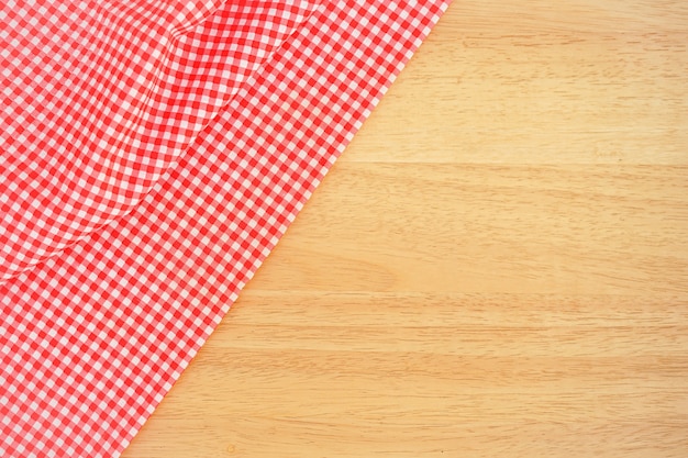 Classic pink plaid fabric or tablecloth on wood desk with copy space