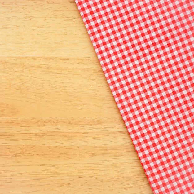 classic pink plaid fabric or tablecloth on wood desk with copy space