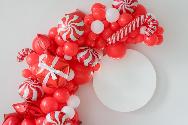 Classic red and white Christmas party decorations with helium balloons. Round frame mockup