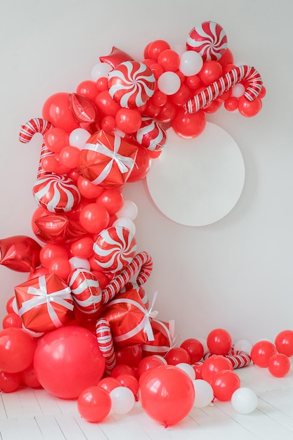Classic red and white Christmas party decorations with helium balloons. Round frame mockup