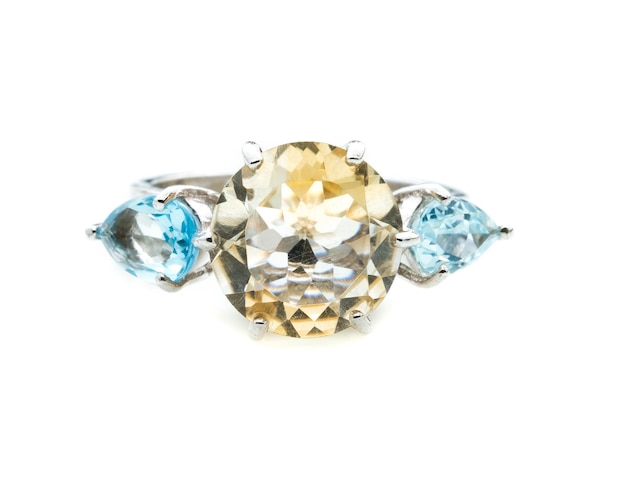 classic ring with a yellow topaz stone on white background