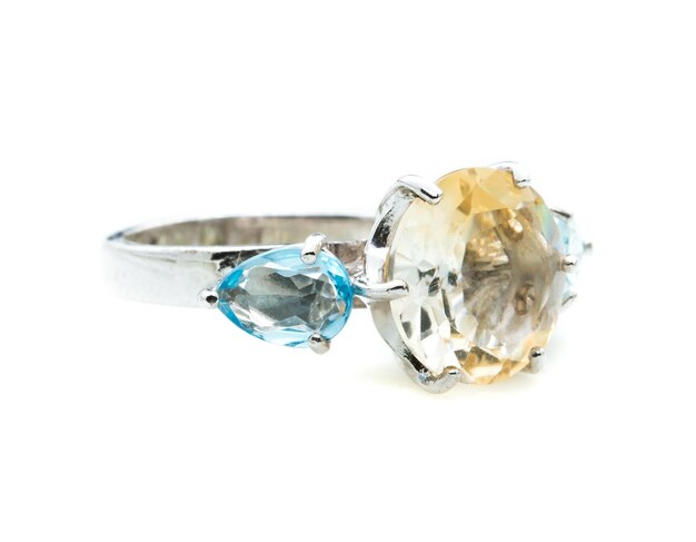 classic ring with a yellow topaz stone on white background