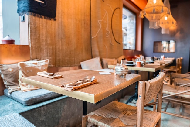 Classic style table and chairs in illuminated restaurant at luxurious resort