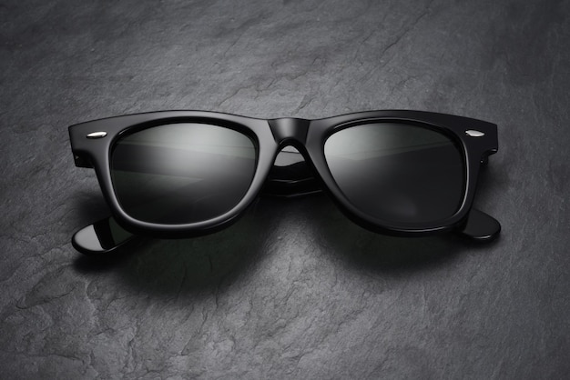 Classic sunglasses on black slate background