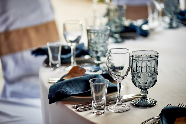 Classic table settingBlue napkin and glasses Banquet