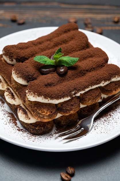 Classico dessert tiramisù su un piatto di ceramica