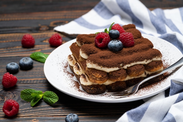 Classic tiramisu dessert with raspberries and blueberries