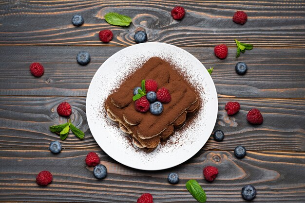 Classic tiramisu dessert with raspberries and blueberries