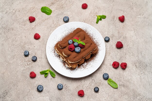 Classic tiramisu dessert with raspberries and blueberries