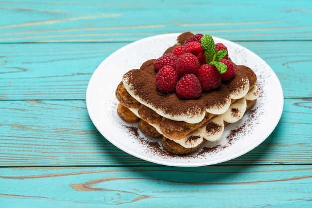 Classic tiramisu dessert with raspberries