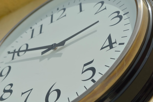 classic vintage wall clock on yellow background