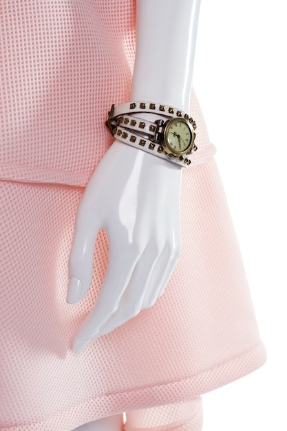 Classic watch on female mannequin. Female mannequin's arm with watch. Vintage watch with leather strap. Round watch with white strap.