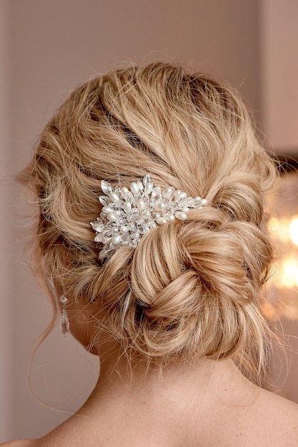 A classic wedding bun the bride\'s hair hairdressing blonde with\
curly hair