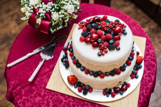 Classic wedding cake with raspberries, strawberries, blackberries and blueberries.