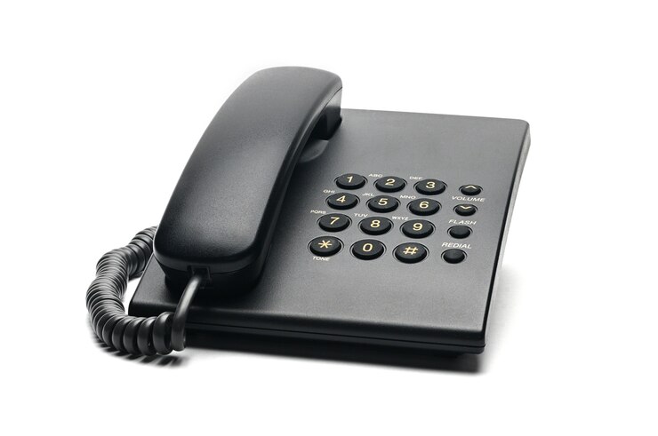 Classic wired telephone used at home and in offices on white