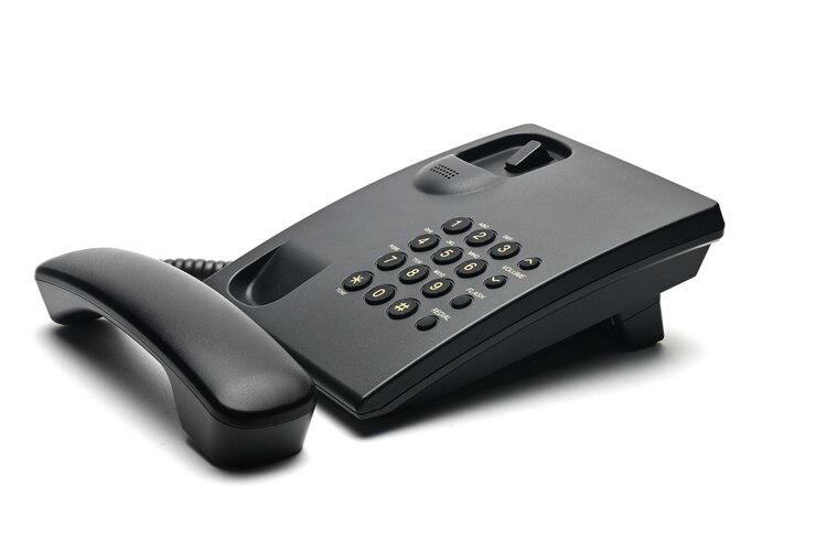 Classic wired telephone used at home and in offices on white