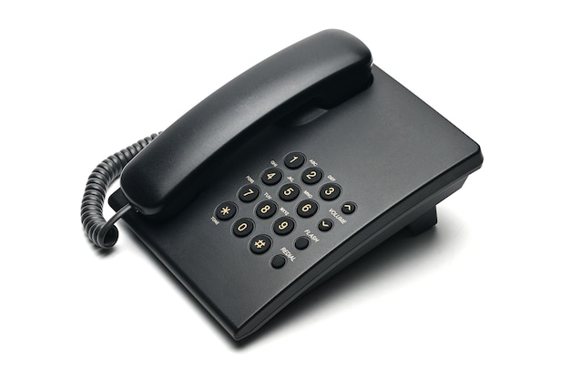 Classic wired telephone on a white isolated background