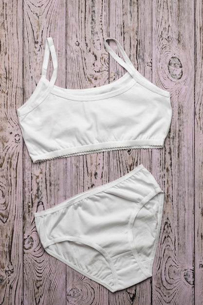 Classic women's underwear on a wooden surface. Classic underwear for girls. Flat lay.