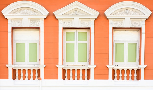 Classic wood window at the old orange concrete building