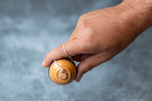 Classic wooden spinning top toy with string