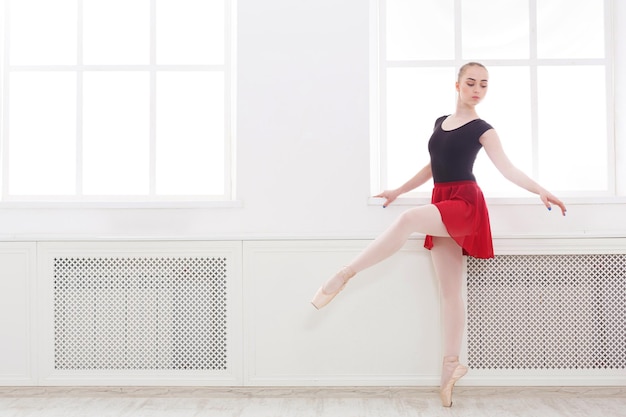 Classical Ballet, ballerina on pointe. Beautiful graceful dancer practice ballet positions. Training, performance, copy space
